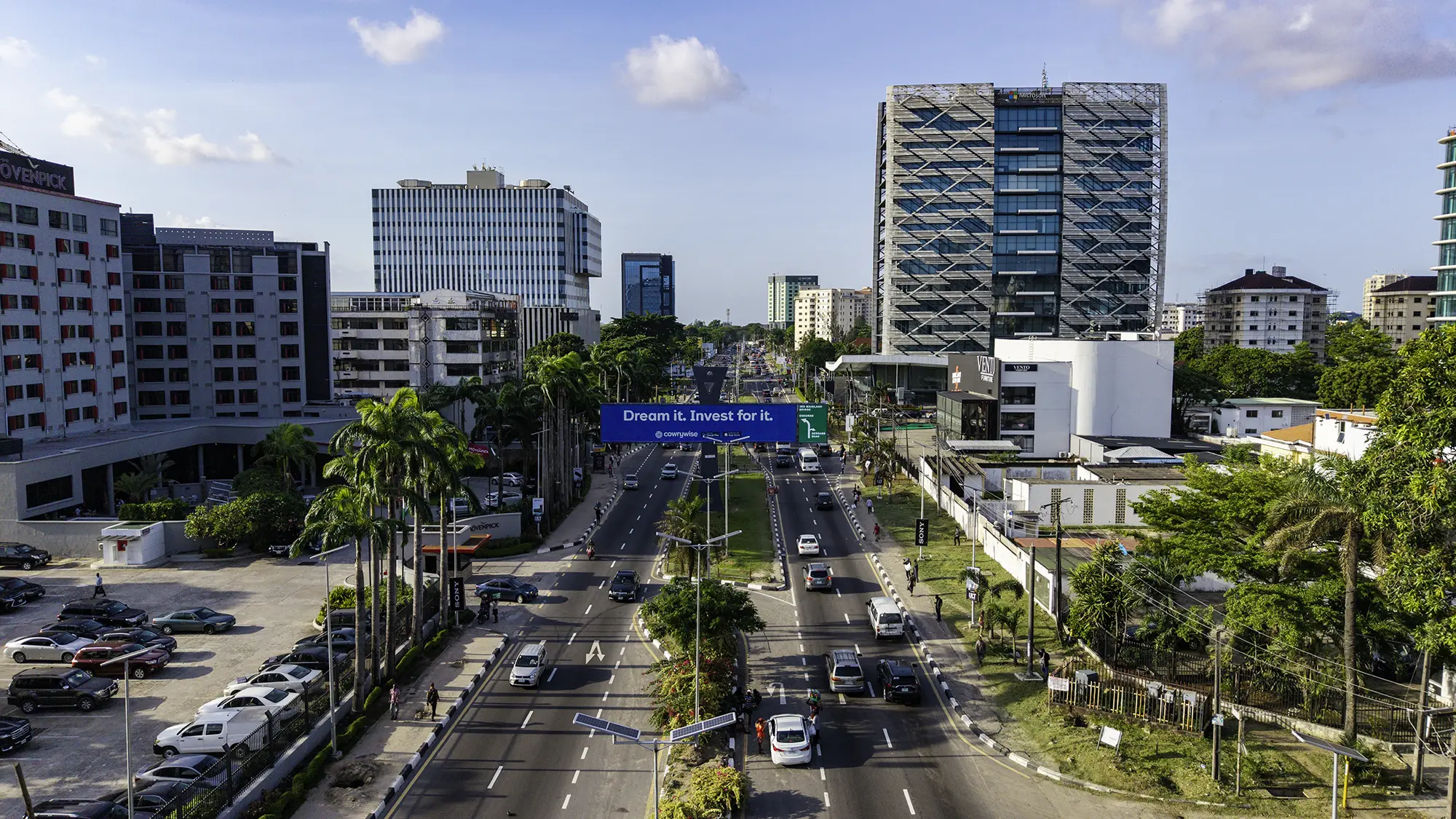 Aerial view of a city road and skyline at dusk